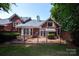 Exterior view of a brick home with a patio area and wrought iron fence at 7554 Bluestar Ln, Charlotte, NC 28226