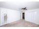 This spacious bedroom features a ceiling fan, carpeted floors, and access to an outdoor area at 7554 Bluestar Ln, Charlotte, NC 28226