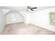 Spacious bedroom with neutral carpet, ceiling fan, and natural light from a window at 7554 Bluestar Ln, Charlotte, NC 28226