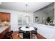 Dining area with modern light fixture, hardwood floors, and large window at 7554 Bluestar Ln, Charlotte, NC 28226