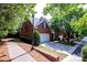 Stunning brick home featuring a well-manicured lawn, attached garages and lush trees at 7554 Bluestar Ln, Charlotte, NC 28226