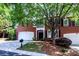 Charming brick home featuring an attached garage, manicured landscaping, and beautiful trees at 7554 Bluestar Ln, Charlotte, NC 28226
