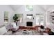 Bright living room featuring a cozy fireplace, soaring ceilings, and hardwood floors at 7554 Bluestar Ln, Charlotte, NC 28226