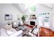 Bright living room featuring a cozy fireplace, soaring ceilings, and hardwood floors at 7554 Bluestar Ln, Charlotte, NC 28226