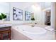 Large soaking tub with tile surround in the main bathroom at 7554 Bluestar Ln, Charlotte, NC 28226
