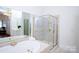 Main bathroom boasts a shower, soaking tub and mirrored walls at 7554 Bluestar Ln, Charlotte, NC 28226