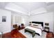 Spacious bedroom with tray ceiling, ceiling fan, and seating area at 7554 Bluestar Ln, Charlotte, NC 28226