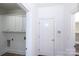 Bright mud room features upper cabinets, access to laundry hookups and an entry door at 7554 Bluestar Ln, Charlotte, NC 28226