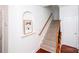 Carpeted staircase with wooden railing and white walls at 7554 Bluestar Ln, Charlotte, NC 28226