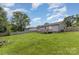 Wide view of the backyard showing the wood deck, fenced yard, and spacious grassy area at 810 4Th St, Kings Mountain, NC 28086