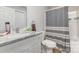 Clean, well-lit bathroom featuring a marble countertop and striped shower curtain at 810 4Th St, Kings Mountain, NC 28086