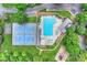 Aerial view of community pool, tennis court, playground, and lush green spaces, providing recreational opportunities at 8417 Hirsch Dr, Charlotte, NC 28277