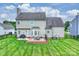 Home exterior showcasing a well-maintained backyard, deck, and manicured lawn at 8417 Hirsch Dr, Charlotte, NC 28277