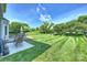 Expansive backyard with well-manicured lawn, wooden deck, and mature trees at 8417 Hirsch Dr, Charlotte, NC 28277