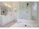 Bright bathroom featuring a glass-enclosed shower, separate tub and double sink vanity at 8417 Hirsch Dr, Charlotte, NC 28277