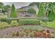 Stone entrance sign to Landen Meadows surrounded by landscaping and colorful flowerbeds at 8417 Hirsch Dr, Charlotte, NC 28277