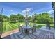 Cozy deck with outdoor dining set overlooking a lush, fenced backyard at 8417 Hirsch Dr, Charlotte, NC 28277