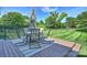 Outdoor dining area on wooden deck with a table and chairs, perfect for entertaining at 8417 Hirsch Dr, Charlotte, NC 28277