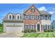 Charming brick and siding two-story home featuring a well-manicured lawn and a two-car garage at 8417 Hirsch Dr, Charlotte, NC 28277