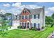 Attractive two-story home with manicured lawn, showcasing a mix of brick and siding exterior at 8417 Hirsch Dr, Charlotte, NC 28277