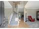 Inviting foyer features a staircase with carpet steps, hardwood floors, and a view into the living room at 8417 Hirsch Dr, Charlotte, NC 28277