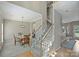 Foyer view featuring a carpeted staircase, hardwood floors, dining room and entry into other rooms at 8417 Hirsch Dr, Charlotte, NC 28277