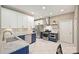 Stylish kitchen featuring stainless steel appliances, white backsplash, and two-tone cabinets at 8417 Hirsch Dr, Charlotte, NC 28277