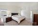 Bright main bedroom featuring a vaulted ceiling, neutral carpet, and a large window for natural light at 8417 Hirsch Dr, Charlotte, NC 28277