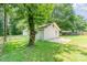 View of the home's back exterior showing the lush green yard with tree at 909 Lakeview St, Kannapolis, NC 28083
