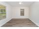 Bright bedroom with windows, and wood-look flooring creating a cozy retreat at 909 Lakeview St, Kannapolis, NC 28083