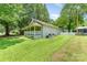 Well-maintained home featuring lush green lawn, vinyl siding, and partial fencing at 909 Lakeview St, Kannapolis, NC 28083