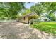 Charming home featuring a welcoming front porch and a spacious, gravel driveway at 909 Lakeview St, Kannapolis, NC 28083