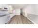 Open concept kitchen and dining area with white cabinetry, stainless appliances and modern flooring at 909 Lakeview St, Kannapolis, NC 28083