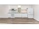 Bright, white kitchen featuring stainless-steel appliances, subway tile backsplash, and wood-look flooring at 909 Lakeview St, Kannapolis, NC 28083