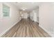 Open-concept living room featuring wood-look flooring and neutral paint, perfect for modern living at 909 Lakeview St, Kannapolis, NC 28083