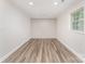 Empty room featuring modern floors, a window, neutral walls, and recessed lighting at 909 Lakeview St, Kannapolis, NC 28083