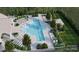 Top-down shot of the community pool with a unique shape and plenty of seating at 9520 Coast Laurel Nw Ave, Concord, NC 28027