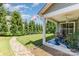 The backyard is shaded by several trees next to the covered patio with outdoor seating at 101 Daybreak Ln, Belmont, NC 28012