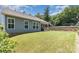 Great-sized backyard with retaining wall, privacy trees, and covered patio with outdoor seating at 101 Daybreak Ln, Belmont, NC 28012