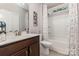 Bright bathroom features a shower-tub, a wooden vanity with a sink, and decorative features at 101 Daybreak Ln, Belmont, NC 28012