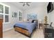 Charming bedroom features a ceiling fan, wood flooring, and natural light from the shuttered window at 101 Daybreak Ln, Belmont, NC 28012