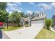 Well-manicured lawn of this home features an attached two-car garage and inviting front entrance at 101 Daybreak Ln, Belmont, NC 28012