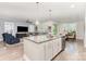 An open kitchen with stainless steel appliances and breakfast bar seating overlooks the living and dining area at 101 Daybreak Ln, Belmont, NC 28012