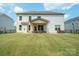 Expansive backyard with a covered patio and well-maintained lawn, perfect for outdoor activities and gatherings at 10437 Paper Birch Dr, Charlotte, NC 28215
