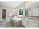 Bright bathroom features an island tub with granite countertops and bright windows at 10437 Paper Birch Dr, Charlotte, NC 28215