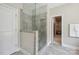 Bathroom with a walk-in shower with stone tile and glass door at 10437 Paper Birch Dr, Charlotte, NC 28215