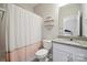 Well-lit bathroom with a shower, toilet, and vanity featuring granite countertops and a decorative mirror at 10437 Paper Birch Dr, Charlotte, NC 28215