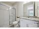 Bright bathroom features a walk-in shower with glass door and granite countertops at 10437 Paper Birch Dr, Charlotte, NC 28215
