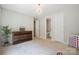 Bedroom with neutral walls, wood dresser, ample room, and access to bathroom at 10437 Paper Birch Dr, Charlotte, NC 28215