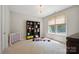 Bedroom with a bookshelf, and ample natural light from the large window at 10437 Paper Birch Dr, Charlotte, NC 28215